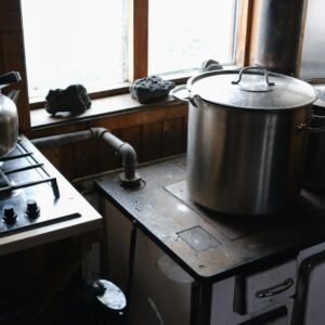 A stove top oven sitting next to a window